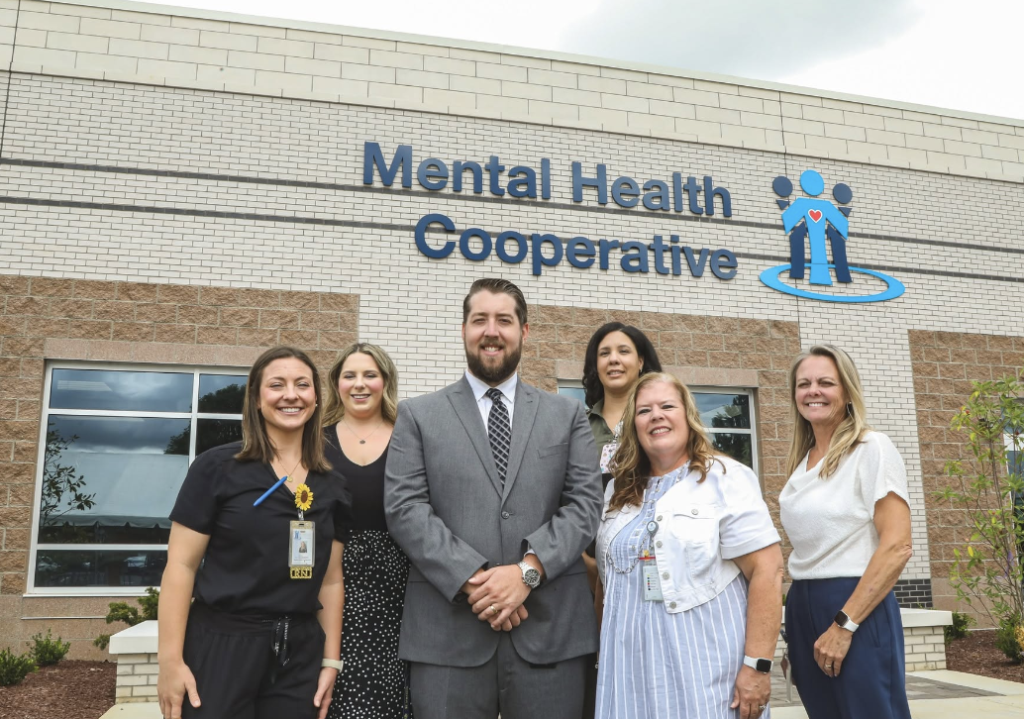 A group of people standing in front of Mental Health Cooperative's Murfreesboro office
