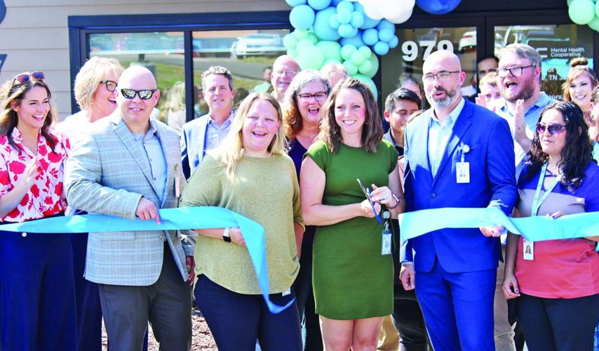 A group of people ribbon cutting